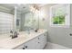 Bathroom features double sink, white cabinets, a large mirror, and natural light at 1003 Fairfax Woods Dr, Apex, NC 27502