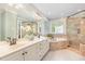 Elegant bathroom featuring double vanity, soaking tub, and glass-enclosed shower at 1003 Fairfax Woods Dr, Apex, NC 27502