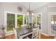 Bright dining area features large windows offering scenic backyard views at 1003 Fairfax Woods Dr, Apex, NC 27502