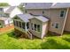 Exterior rear view of a home with a screened in porch and a well maintained lawn at 1003 Fairfax Woods Dr, Apex, NC 27502