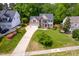 Aerial view of a charming two-story home with manicured lawn and driveway at 1003 Fairfax Woods Dr, Apex, NC 27502