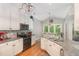 Charming kitchen boasts granite counters, stainless appliances, and modern lighting at 1003 Fairfax Woods Dr, Apex, NC 27502