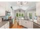 Spacious kitchen features white cabinetry, granite counters, and eat-in breakfast area at 1003 Fairfax Woods Dr, Apex, NC 27502