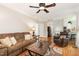 Spacious living room with hardwood floors, comfortable furniture, and access to the kitchen at 1003 Fairfax Woods Dr, Apex, NC 27502