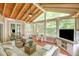 Stylish sunroom featuring vaulted wood ceilings, lots of windows, and comfortable wicker seating at 1003 Fairfax Woods Dr, Apex, NC 27502