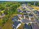 An aerial view of residential neighborhood surrounded by lush green forest with tree lined streets at 1005 Whispering Creek Ct, Knightdale, NC 27545