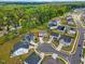 Aerial view of a residential neighborhood surrounded by lush green forest and tree lined streets at 1005 Whispering Creek Ct, Knightdale, NC 27545