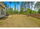 A large backyard with grass and wooden fencing at 1005 Whispering Creek Ct, Knightdale, NC 27545