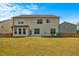 Expansive backyard with manicured lawn, fenced perimeter, and neutral siding with multiple windows at 1005 Whispering Creek Ct, Knightdale, NC 27545