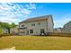 Large backyard featuring well-maintained lawn, secure wooden fencing, and back of home at 1005 Whispering Creek Ct, Knightdale, NC 27545