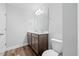 Bathroom featuring dual sinks, granite countertops, and wooden cabinets at 1005 Whispering Creek Ct, Knightdale, NC 27545