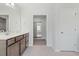 Bathroom with a vanity, large mirror, tile flooring, and a view into an attached bathroom at 1005 Whispering Creek Ct, Knightdale, NC 27545