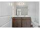 Bathroom featuring dual sinks, granite countertops, and wooden cabinets at 1005 Whispering Creek Ct, Knightdale, NC 27545