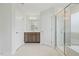 Bathroom with double doors, vanity, mirror, walk-in shower with glass door, and tile flooring at 1005 Whispering Creek Ct, Knightdale, NC 27545