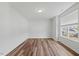 Bright bedroom with hardwood floors, neutral walls, and a large window offering ample natural light at 1005 Whispering Creek Ct, Knightdale, NC 27545