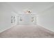 Bright bedroom with tray ceiling, fan, and plenty of natural light streaming through dual windows at 1005 Whispering Creek Ct, Knightdale, NC 27545