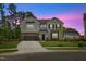 Inviting two-story home at twilight with a well-kept lawn and charming curb appeal at 1005 Whispering Creek Ct, Knightdale, NC 27545