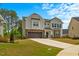 Beautiful two-story home with a manicured lawn and a spacious two-car garage at 1005 Whispering Creek Ct, Knightdale, NC 27545