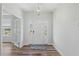 Bright foyer with hardwood floors, chandelier, and views to other rooms through glass doors at 1005 Whispering Creek Ct, Knightdale, NC 27545