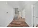 Open hallway with hardwood floors, staircase, and views into other rooms of the home at 1005 Whispering Creek Ct, Knightdale, NC 27545