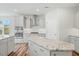 Modern kitchen featuring a spacious island with granite countertops, stainless steel appliances, and stylish cabinetry at 1005 Whispering Creek Ct, Knightdale, NC 27545
