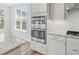 Stainless steel oven and microwave appliances are set into light-colored cabinets in this well-lit kitchen at 1005 Whispering Creek Ct, Knightdale, NC 27545