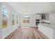 Bright open kitchen features stainless appliances, large windows, and a center island with granite countertops at 1005 Whispering Creek Ct, Knightdale, NC 27545
