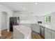 Open-concept kitchen featuring modern appliances, granite countertops, and seamless flow into the adjacent living area at 1005 Whispering Creek Ct, Knightdale, NC 27545