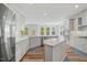 Bright kitchen with stainless steel appliances, center island, granite countertops, and ample cabinet space at 1005 Whispering Creek Ct, Knightdale, NC 27545