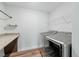 Bright laundry room with stainless steel washer and dryer, with built in granite counter and shelving at 1005 Whispering Creek Ct, Knightdale, NC 27545