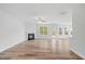 An open-concept living room features a fireplace, ceiling fan, and views into the kitchen and backyard at 1005 Whispering Creek Ct, Knightdale, NC 27545