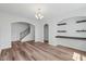 Spacious living room featuring hardwood floors, open archways, and built-in shelving at 1005 Whispering Creek Ct, Knightdale, NC 27545