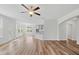 Spacious living room featuring an archway into another room, a ceiling fan, and an eat-in kitchen at 1005 Whispering Creek Ct, Knightdale, NC 27545