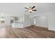 Open concept living area with views to kitchen featuring stainless steel appliances and an arched hallway at 1005 Whispering Creek Ct, Knightdale, NC 27545
