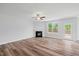 Bright living room features a fireplace, ceiling fan, and a glass door leading to the backyard at 1005 Whispering Creek Ct, Knightdale, NC 27545
