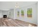 Bright living room with lots of windows, a fireplace, hardwood floors, and natural light at 1005 Whispering Creek Ct, Knightdale, NC 27545
