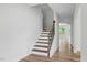 Entryway staircase featuring hardwood treads, open floorplan, and natural light at 1005 Whispering Creek Ct, Knightdale, NC 27545