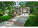 Charming home with a spacious driveway, stone facade, manicured lawn, and attached garage at 10113 San Remo Pl, Wake Forest, NC 27587