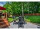 Serene backyard with a dining set and a lush green lawn at 10113 San Remo Pl, Wake Forest, NC 27587