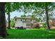 Lush backyard featuring a deck, patio, and mature trees for shade at 10113 San Remo Pl, Wake Forest, NC 27587