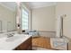 Bathroom featuring a sink with vanity, wood paneled walls, bench and window at 10113 San Remo Pl, Wake Forest, NC 27587
