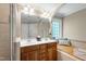 This bathroom features a double vanity, mirror, corner bench and window at 10113 San Remo Pl, Wake Forest, NC 27587
