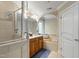 The bathroom features a double vanity, mirror, corner bench and shower behind the door at 10113 San Remo Pl, Wake Forest, NC 27587