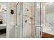 A bathroom featuring a glass-enclosed shower, vanity with sink, and white tiled walls at 10113 San Remo Pl, Wake Forest, NC 27587