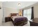 Inviting bedroom featuring neutral walls, plush carpet, and a inviting bed with stylish bedding and wood furniture at 10113 San Remo Pl, Wake Forest, NC 27587