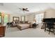 This bonus room has a large couch, desk, and mirrors and is well-lit from natural light at 10113 San Remo Pl, Wake Forest, NC 27587