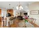 Eat-in kitchen flows into dining and living area with bar stool seating and open concept design at 10113 San Remo Pl, Wake Forest, NC 27587