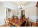 Dining room with elegant chandelier and trim, adjoining kitchen area at 10113 San Remo Pl, Wake Forest, NC 27587