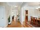Bright hallway with hardwood floors that connects the dining area and living room at 10113 San Remo Pl, Wake Forest, NC 27587