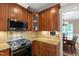 Well-equipped kitchen features stainless steel appliances, granite countertops, and custom wood cabinetry at 10113 San Remo Pl, Wake Forest, NC 27587